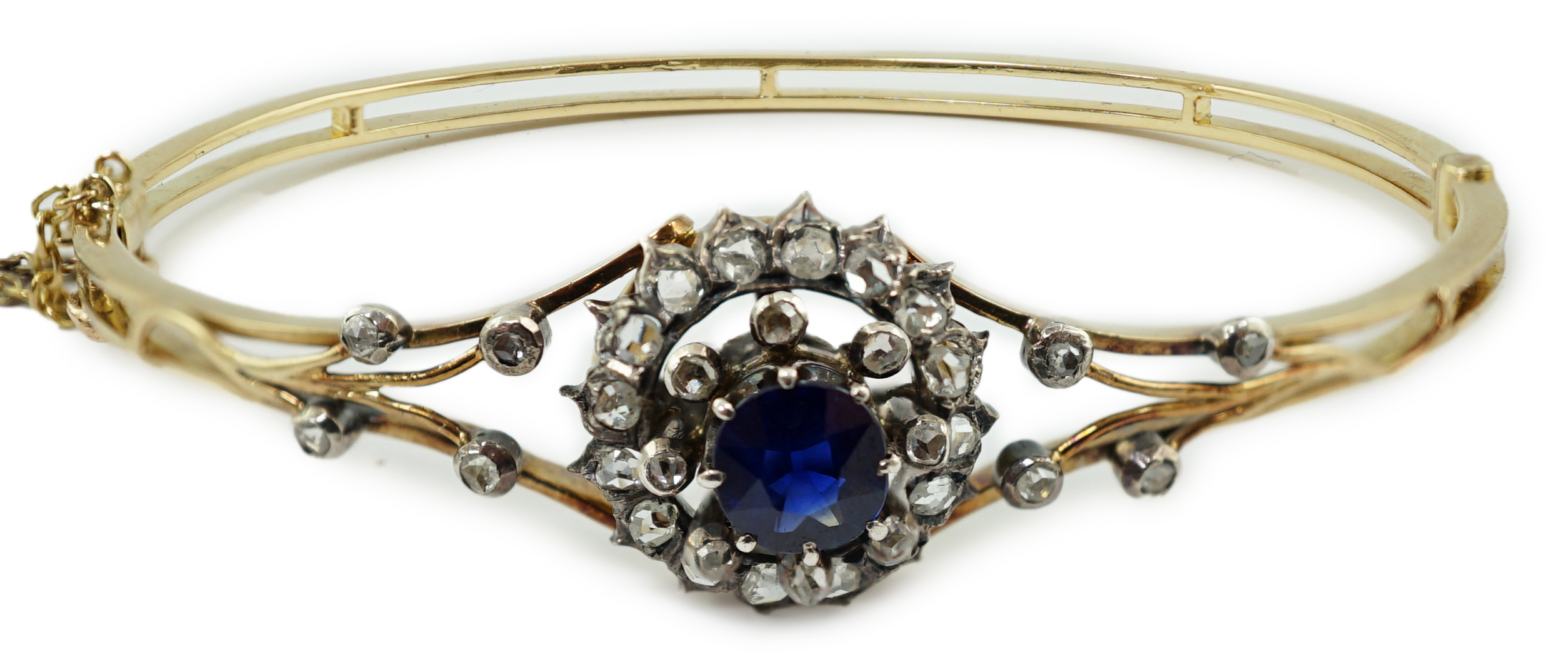 A Victorian gold, sapphire and diamond cluster set hinged bangle